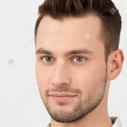 Joyful white young-adult male with short  brown hair and brown eyes