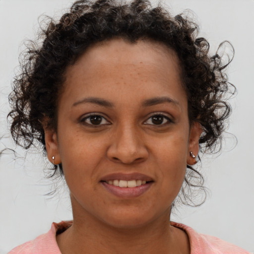 Joyful black young-adult female with short  brown hair and brown eyes