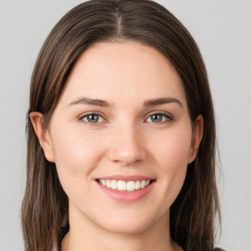 Joyful white young-adult female with long  brown hair and grey eyes