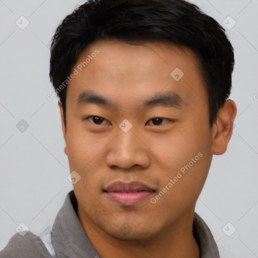 Joyful asian young-adult male with short  black hair and brown eyes