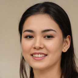 Joyful asian young-adult female with long  brown hair and brown eyes