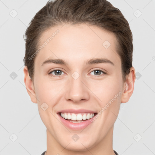 Joyful white young-adult female with short  brown hair and grey eyes