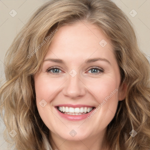 Joyful white young-adult female with medium  brown hair and green eyes