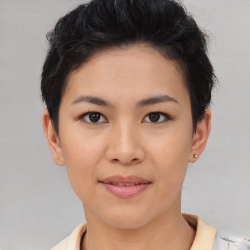 Joyful asian young-adult female with short  brown hair and brown eyes
