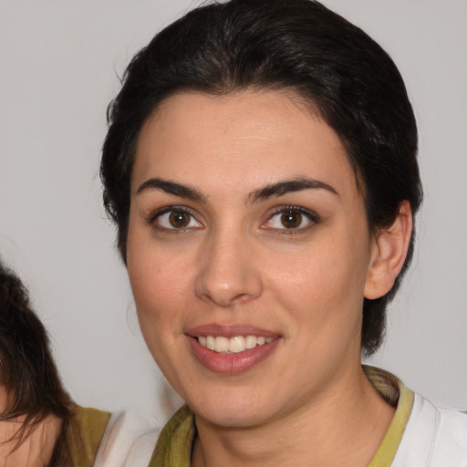 Joyful white young-adult female with medium  brown hair and brown eyes