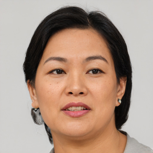 Joyful asian adult female with short  brown hair and brown eyes