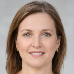 Joyful white young-adult female with long  brown hair and green eyes