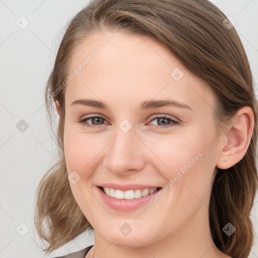 Joyful white young-adult female with medium  brown hair and blue eyes