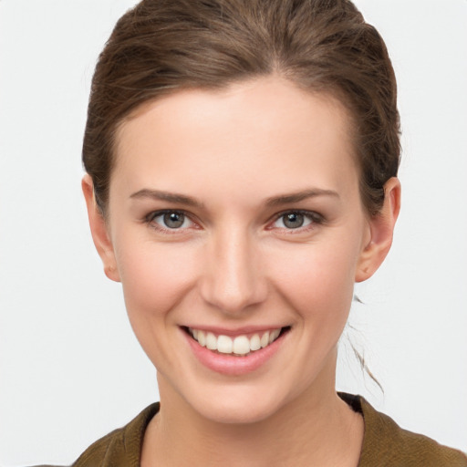 Joyful white young-adult female with short  brown hair and grey eyes