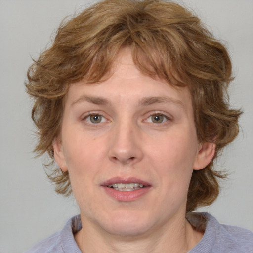 Joyful white adult female with medium  brown hair and blue eyes