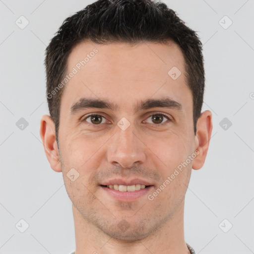 Joyful white young-adult male with short  brown hair and brown eyes