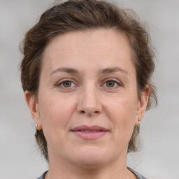 Joyful white adult female with medium  brown hair and grey eyes