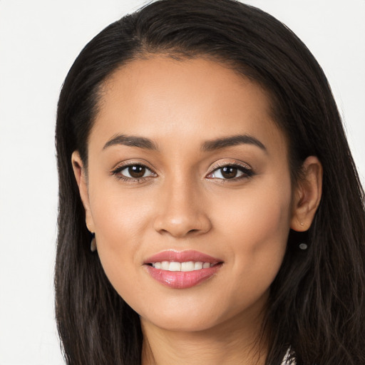 Joyful latino young-adult female with long  black hair and brown eyes