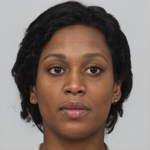 Neutral black young-adult female with long  brown hair and brown eyes
