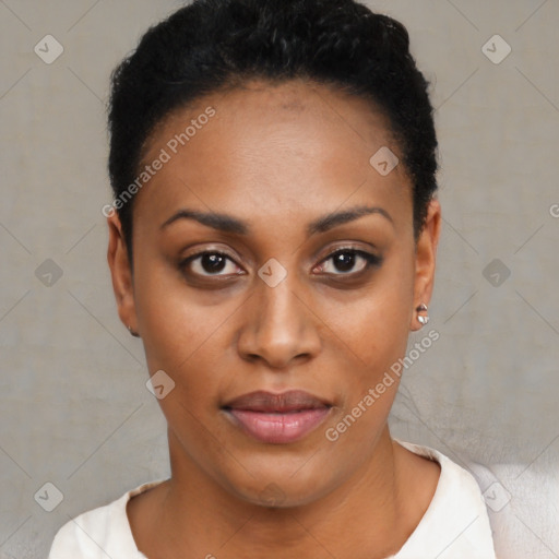 Joyful black young-adult female with short  black hair and brown eyes