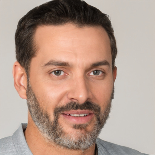 Joyful white adult male with short  brown hair and brown eyes