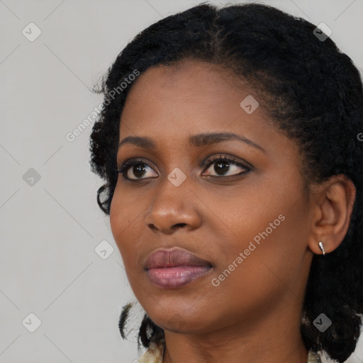 Joyful black young-adult female with medium  black hair and brown eyes