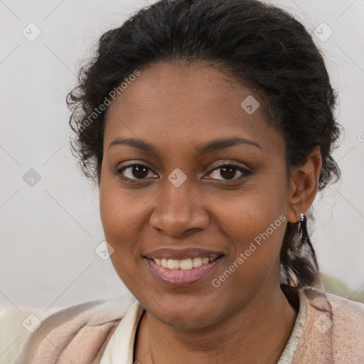 Joyful black young-adult female with short  brown hair and brown eyes