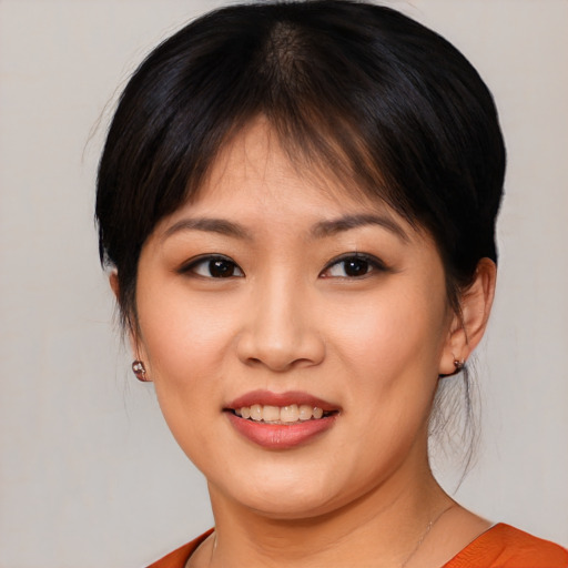 Joyful asian young-adult female with medium  brown hair and brown eyes