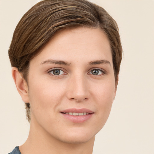 Joyful white young-adult female with short  brown hair and grey eyes