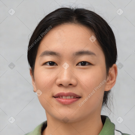 Joyful asian young-adult female with short  brown hair and brown eyes