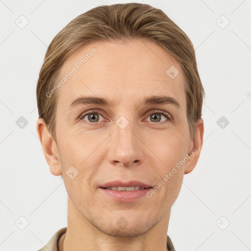 Joyful white young-adult male with short  brown hair and grey eyes