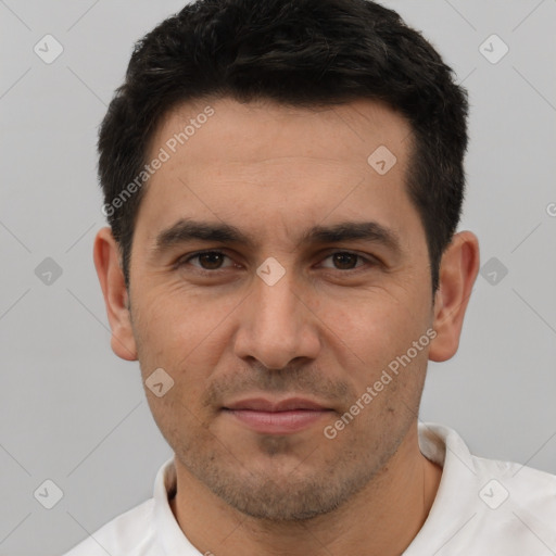 Joyful white adult male with short  black hair and brown eyes