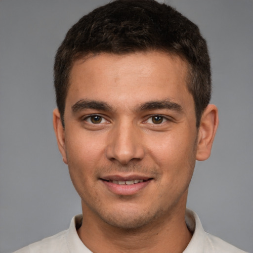 Joyful white young-adult male with short  brown hair and brown eyes