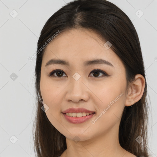 Joyful asian young-adult female with long  brown hair and brown eyes