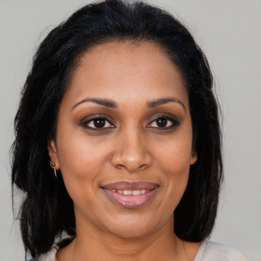 Joyful black young-adult female with medium  brown hair and brown eyes