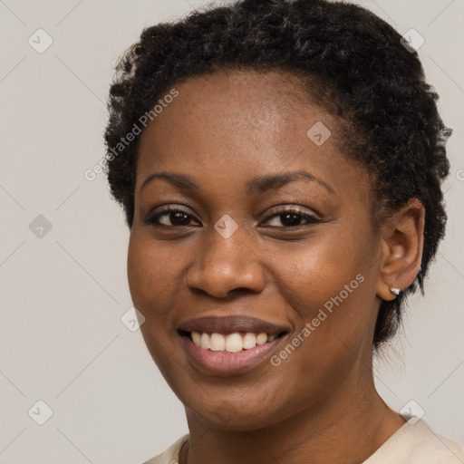 Joyful black young-adult female with short  brown hair and brown eyes