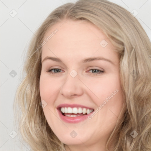 Joyful white young-adult female with long  brown hair and blue eyes