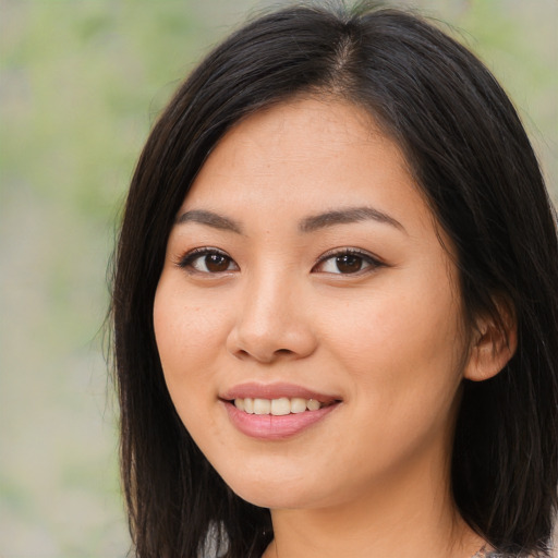 Joyful asian young-adult female with long  brown hair and brown eyes