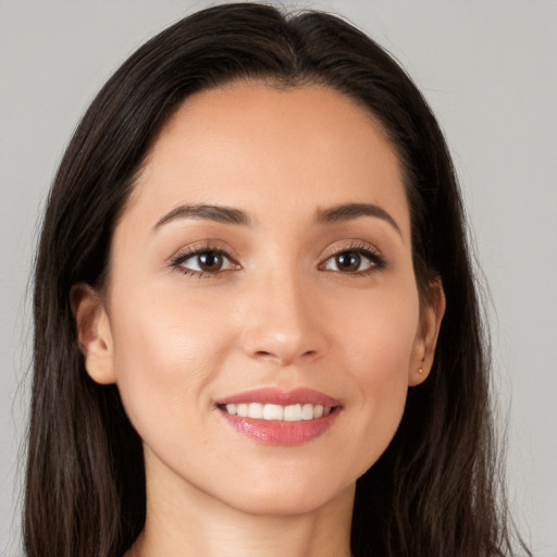 Joyful white young-adult female with long  brown hair and brown eyes