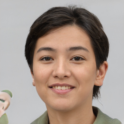 Joyful asian young-adult female with medium  brown hair and brown eyes