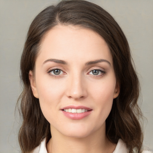 Joyful white young-adult female with medium  brown hair and green eyes