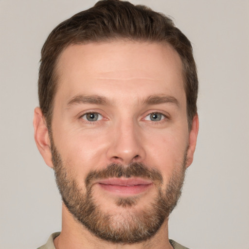 Joyful white young-adult male with short  brown hair and brown eyes