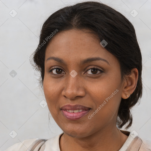 Joyful black young-adult female with medium  brown hair and brown eyes