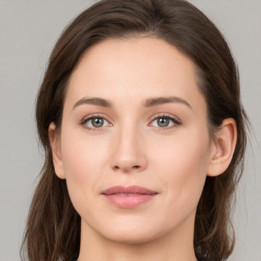 Joyful white young-adult female with medium  brown hair and grey eyes