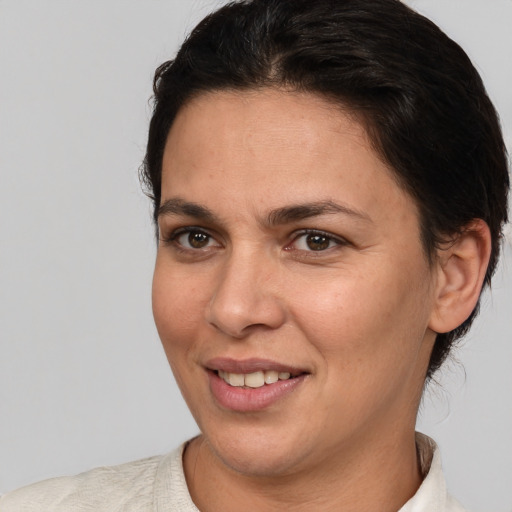 Joyful white adult female with short  brown hair and brown eyes