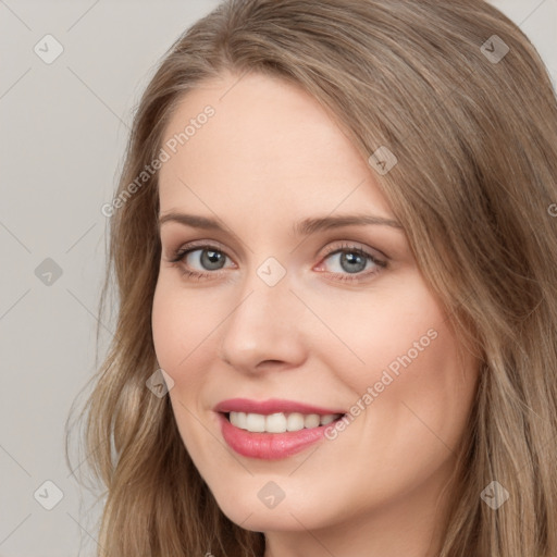 Joyful white young-adult female with long  brown hair and blue eyes