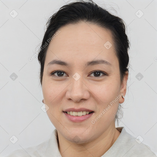 Joyful asian young-adult female with short  brown hair and brown eyes