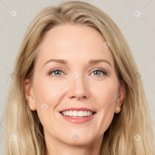 Joyful white adult female with long  brown hair and blue eyes