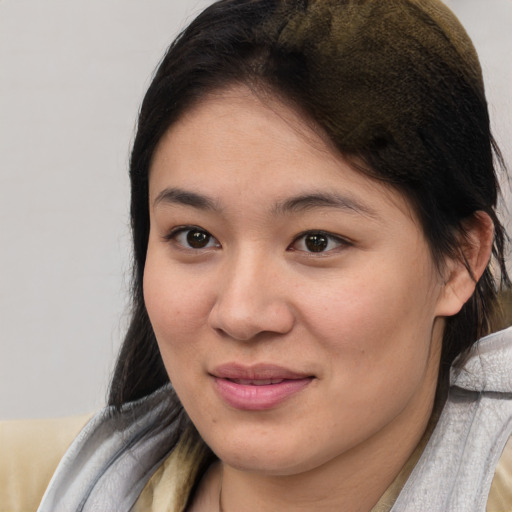 Joyful asian young-adult female with medium  brown hair and brown eyes
