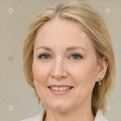 Joyful white adult female with medium  brown hair and blue eyes