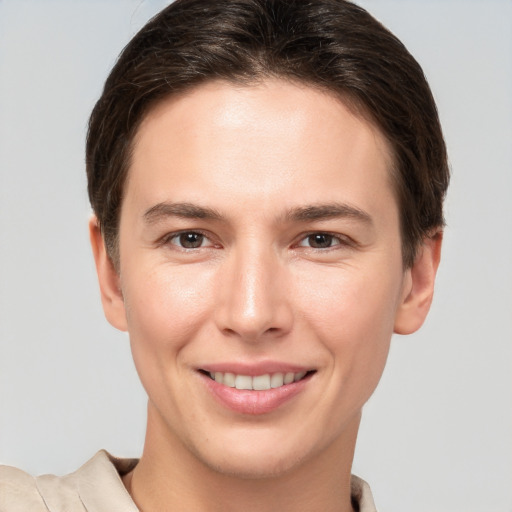 Joyful white young-adult female with short  brown hair and brown eyes