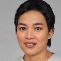 Joyful asian young-adult female with medium  brown hair and brown eyes