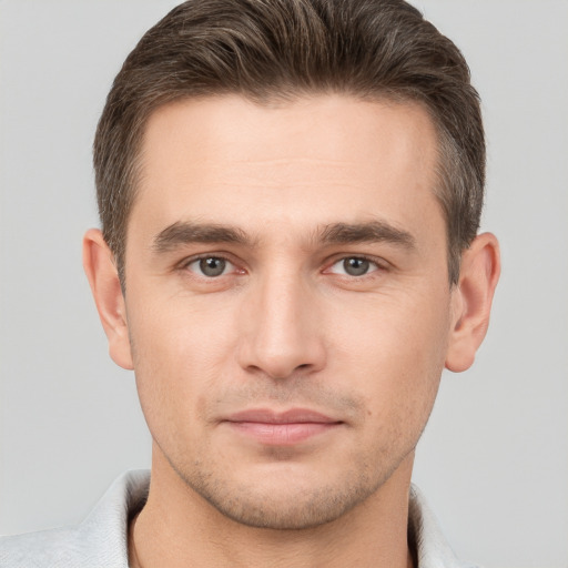 Joyful white young-adult male with short  brown hair and brown eyes