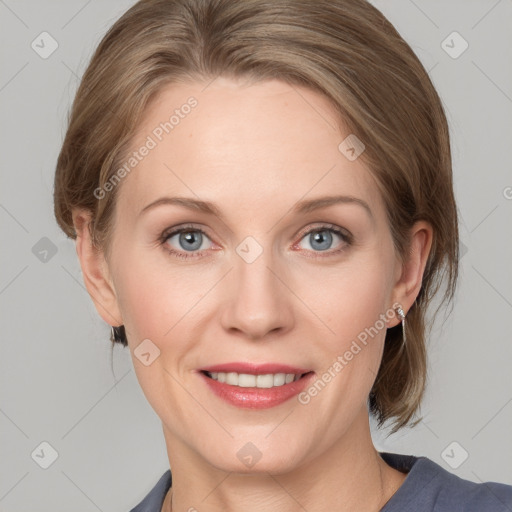 Joyful white adult female with medium  brown hair and blue eyes