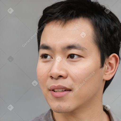 Joyful asian young-adult male with short  black hair and brown eyes